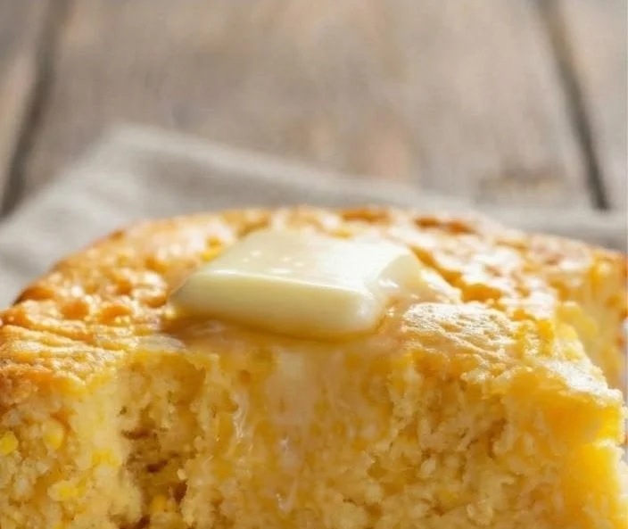 Amish sour cream cornbread served in a rustic dish with ingredients surrounding it