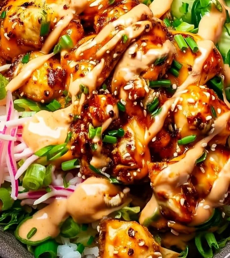 Delicious Bang Bang Chicken Bowl featuring a mix of chicken, spicy sauce, and fresh vegetables.