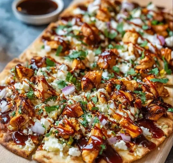 Delicious BBQ chicken flatbread topped with fresh vegetables and herbs