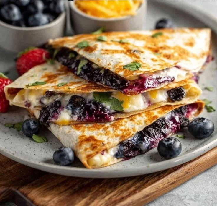 Blueberry breakfast quesadilla with melted cheese and fresh blueberries