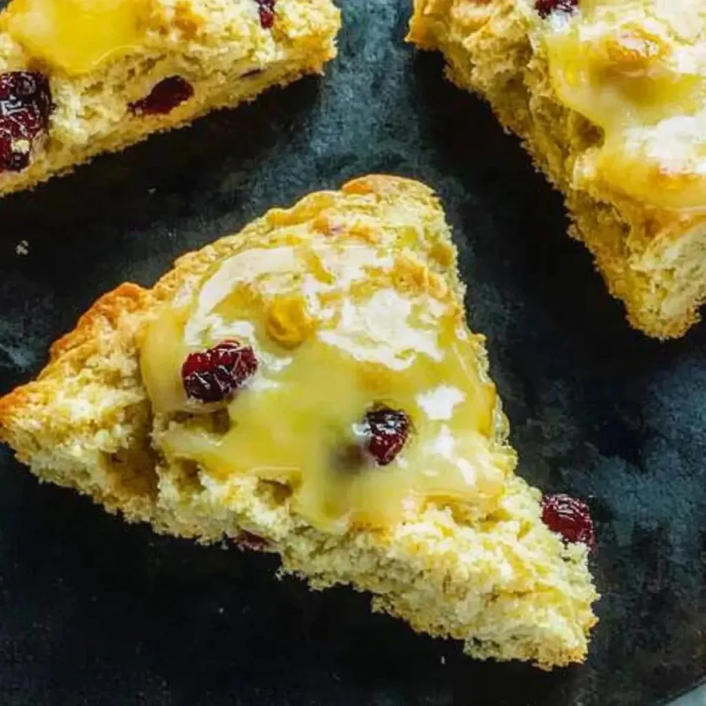 Freshly baked Cranberry Orange Scones on a wooden table