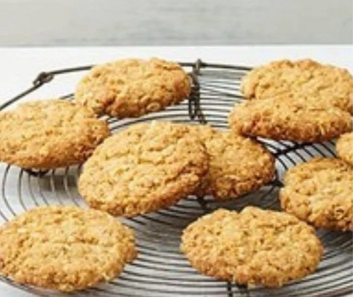 Crispy homemade oat biscuits that melt in your mouth, displayed on a rustic table.