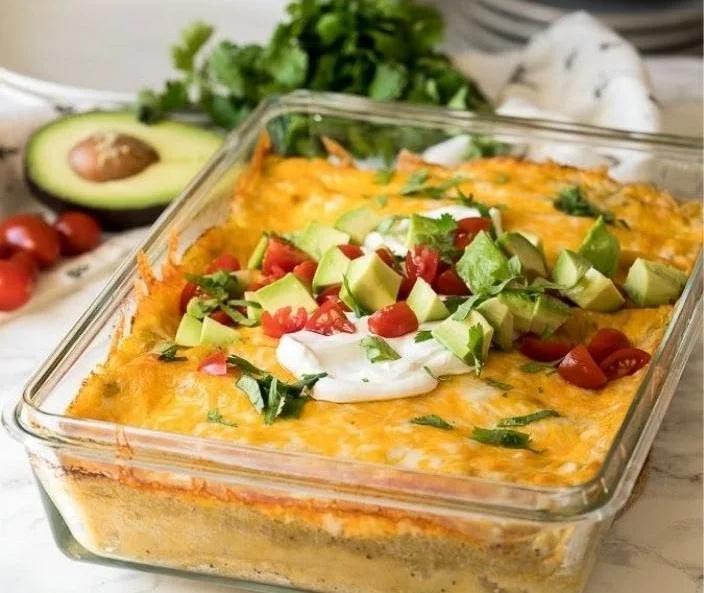 Delicious green chile chicken enchilada casserole served in a baking dish