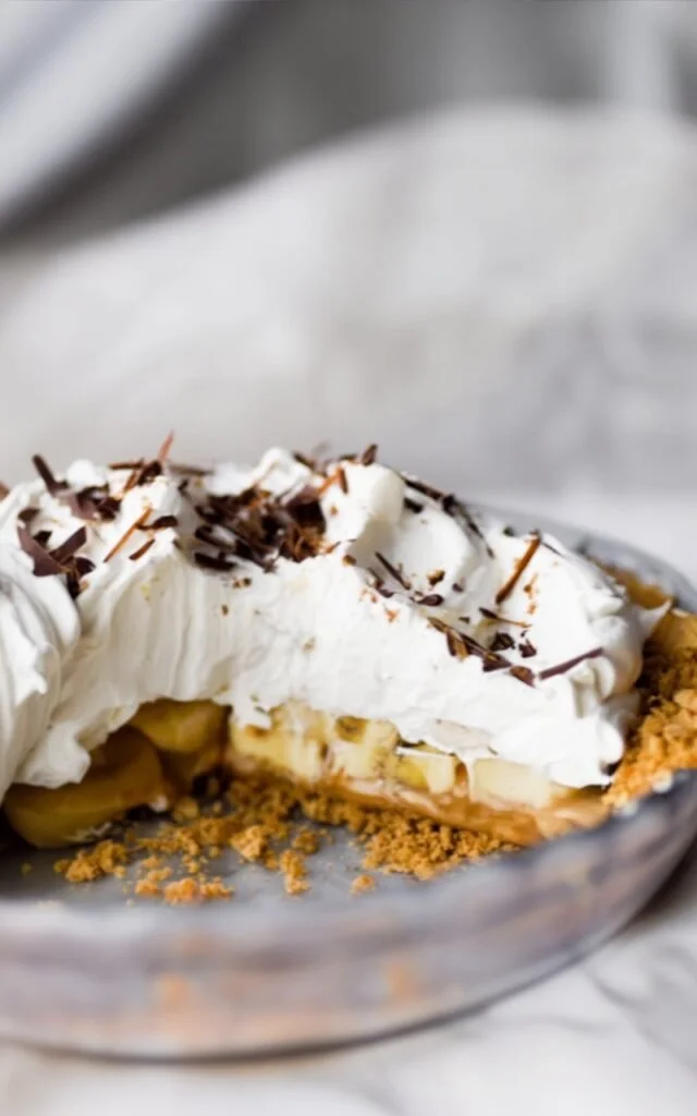 Delicious no-bake banoffee pie topped with whipped cream and bananas