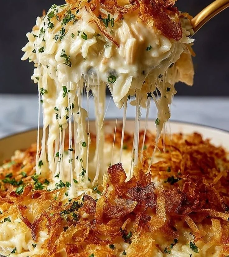 Savory French onion chicken rice bake topped with cheese and herbs