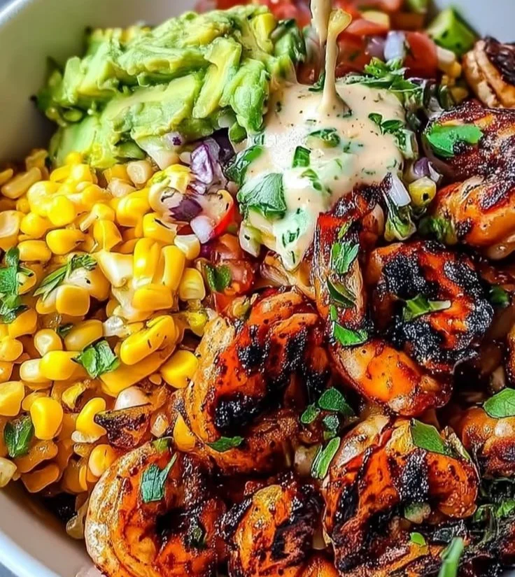 Grilled shrimp bowl with colorful vegetables and flavorful seasonings.