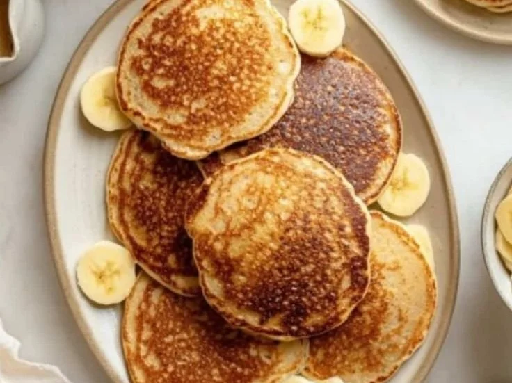 Healthy banana oatmeal pancakes served with fresh fruit