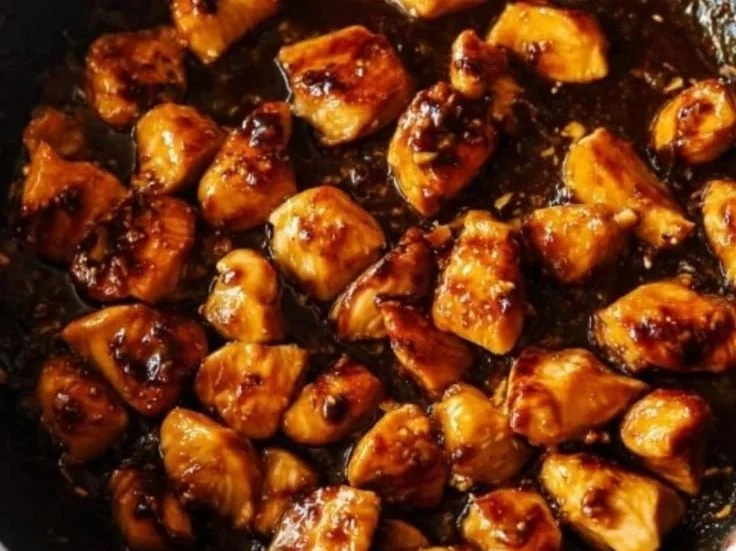 Healthy sesame chicken stir-fry served with vegetables and sesame seeds