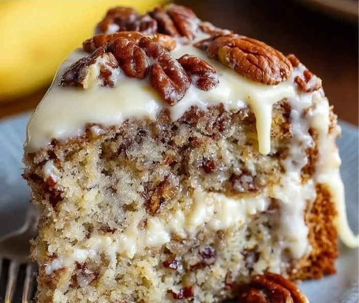 Delicious slice of luscious banana pecan cake with walnuts on a plate