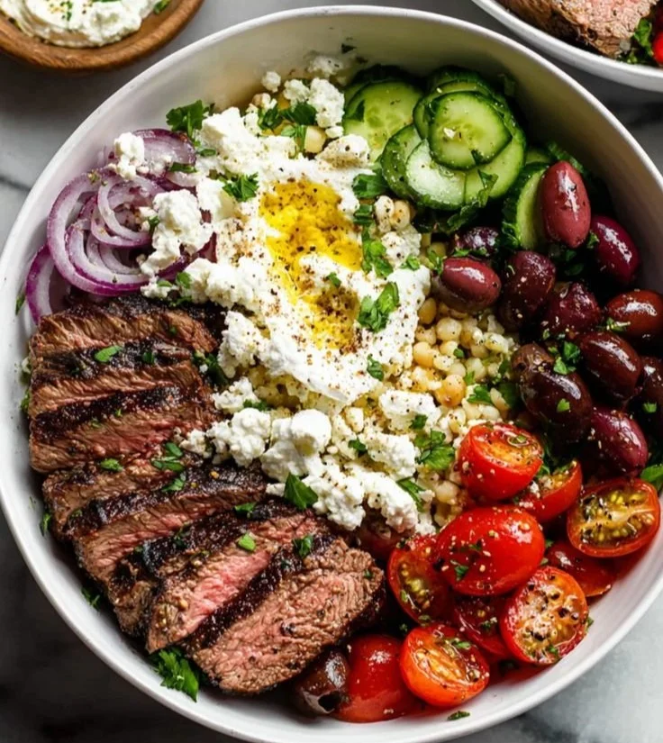 Delicious Mediterranean steak bowls with fresh vegetables and herbs
