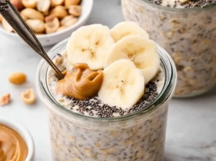 Bowl of peanut butter banana overnight oats topped with slices of banana and nuts