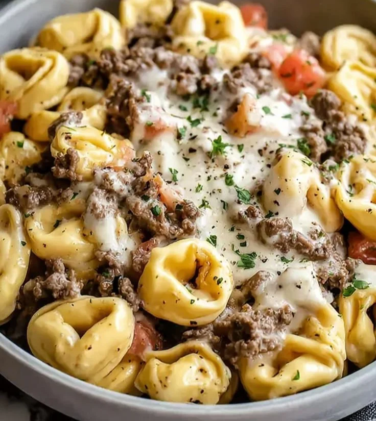 Philly Cheesesteak Tortellini served in a bowl with cheese and peppers