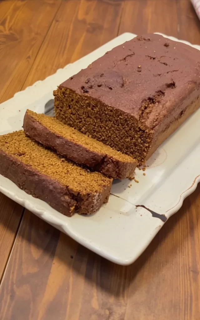 Delicious slice of moist pumpkin gingerbread with spices and frosting.