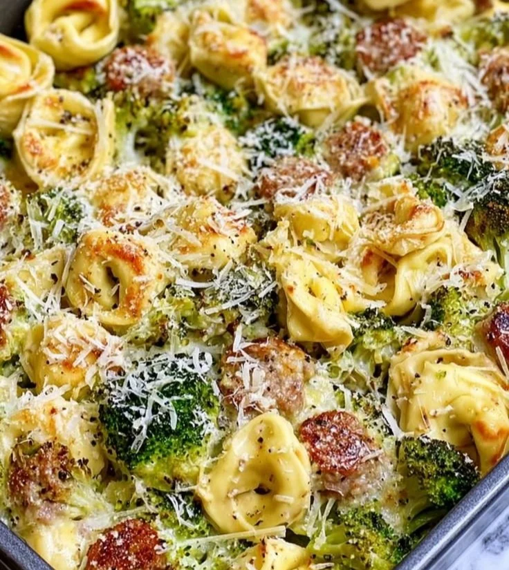 Sheet pan broccoli tortellini bake with colorful vegetables and cheese.