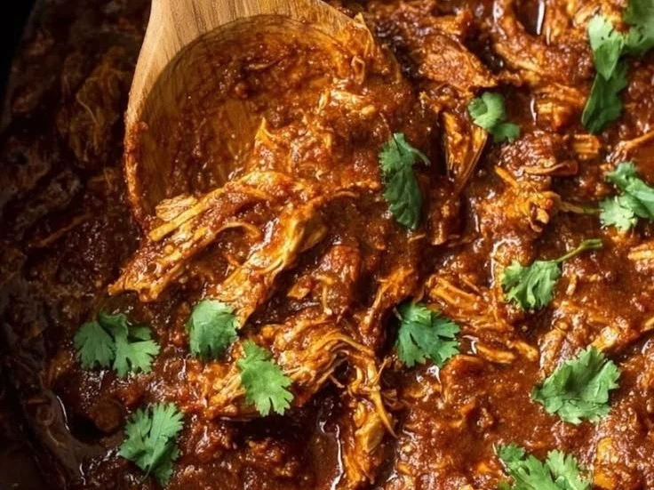 Slow Cooker Butter Chicken served with rice and garnished with cilantro