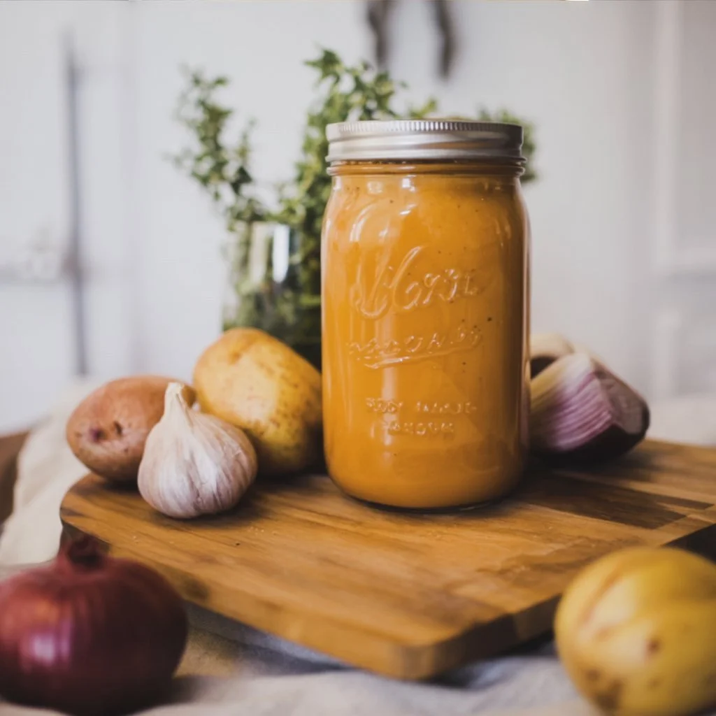 Creamy and delicious vegan cheese sauce served in a bowl with herbs