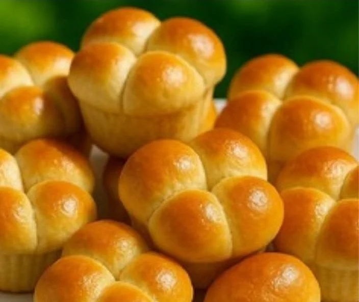 Freshly baked soft Cloverleaf Dinner Rolls served warm on a plate.