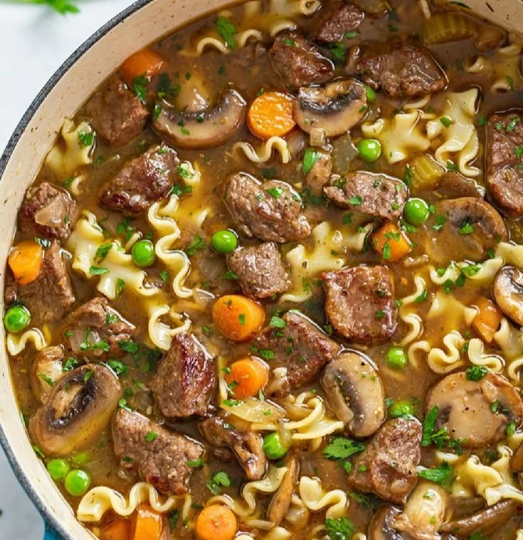 Delicious bowl of beef noodle soup with fresh herbs and spices