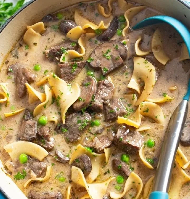 Bowl of delicious Beef Stroganoff Soup topped with fresh herbs