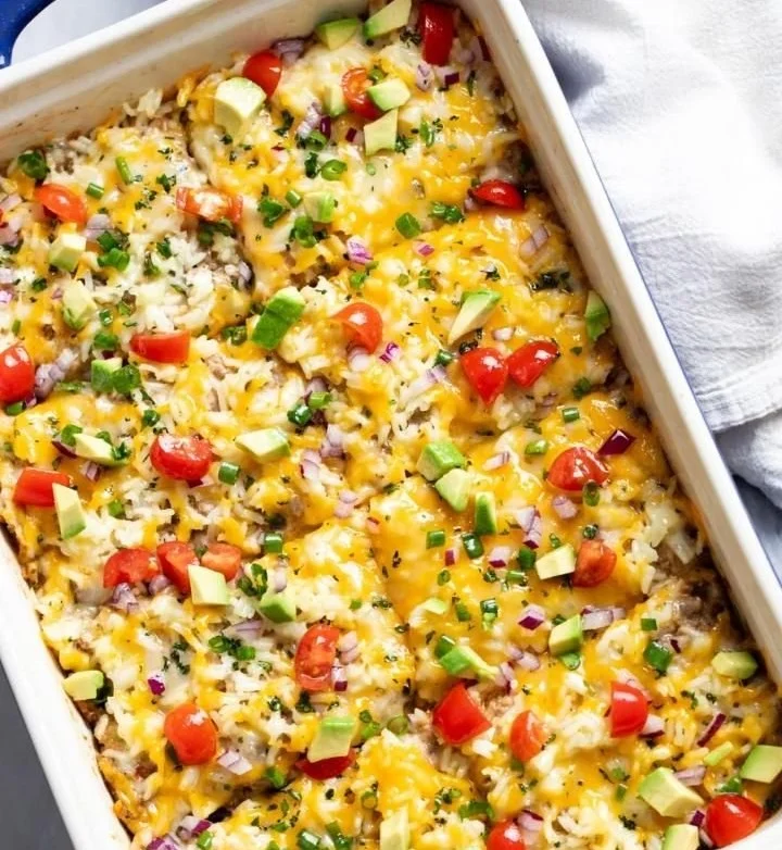 Deliciously layered burrito casserole topped with cheese and garnished with fresh cilantro