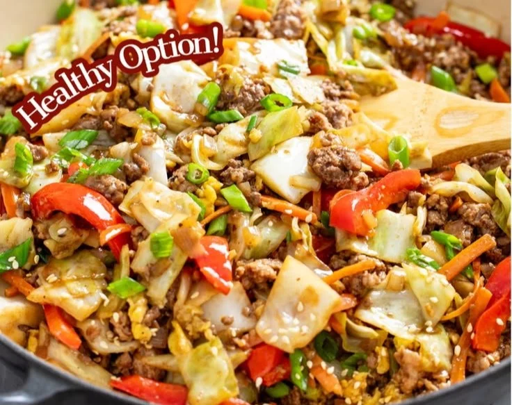 Colorful cabbage stir fry with vegetables and spices in a skillet