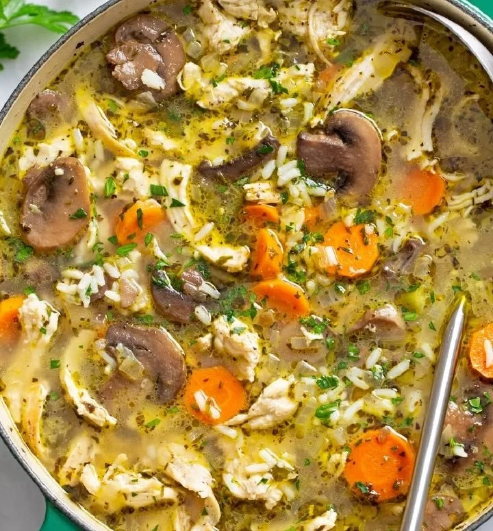 Bowl of homemade Chicken Mushroom Soup with fresh herbs and vegetables