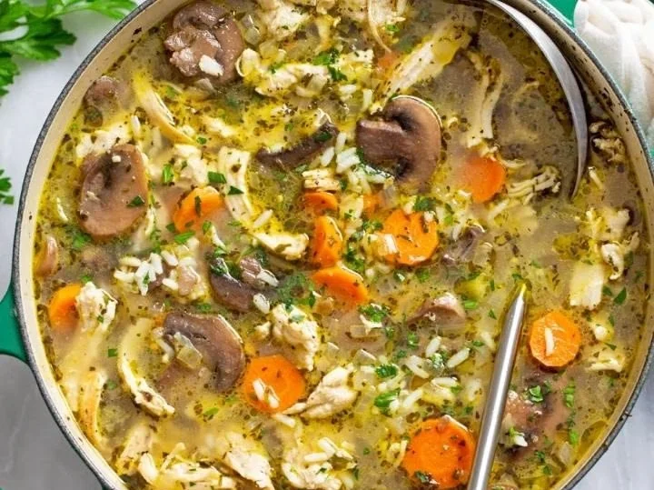 Bowl of Chicken Mushroom Soup with fresh herbs and mushrooms.
