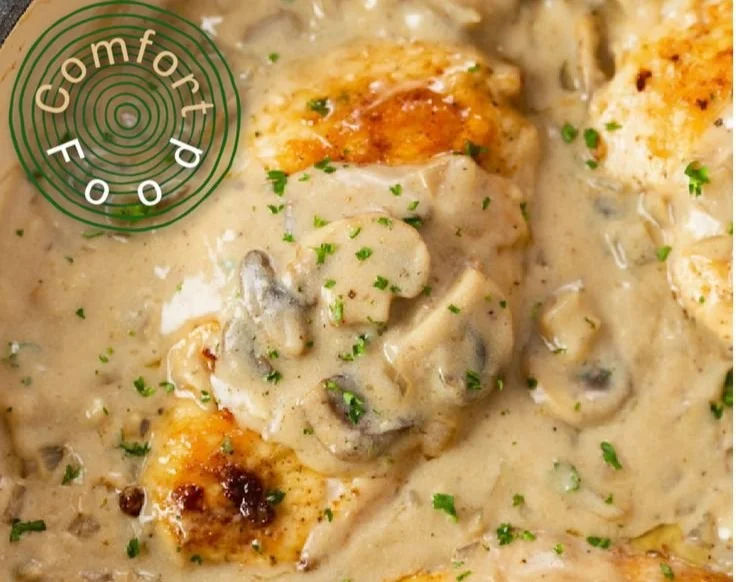 Creamy Chicken Stroganoff served on a plate with noodles and garnished with parsley