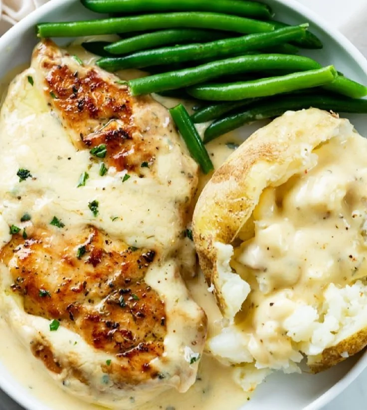 Delicious creamy ranch chicken served on a plate with herbs and spices