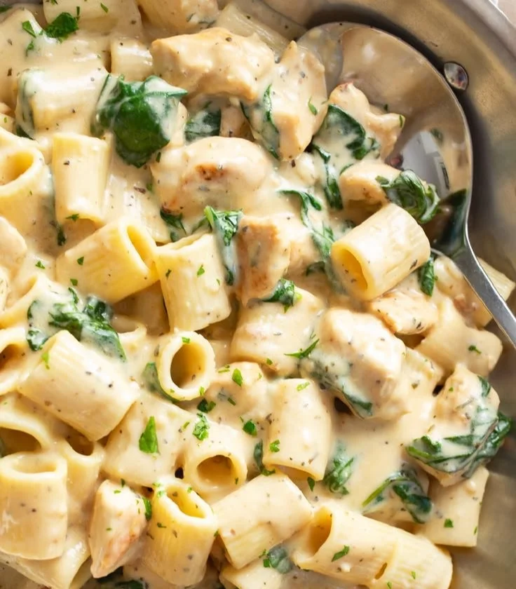 Delicious creamy spinach pasta garnished with fresh herbs