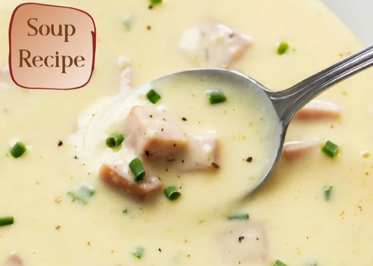 Bowls of hearty ham and potato soup with fresh herbs on top