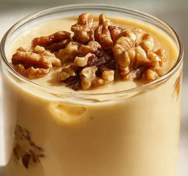 Iranian Date Walnut and Ginger Drink in a glass with dates and walnuts
