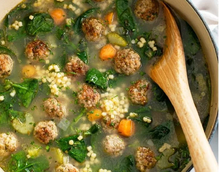 Bowl of Italian Wedding Soup with meatballs and greens