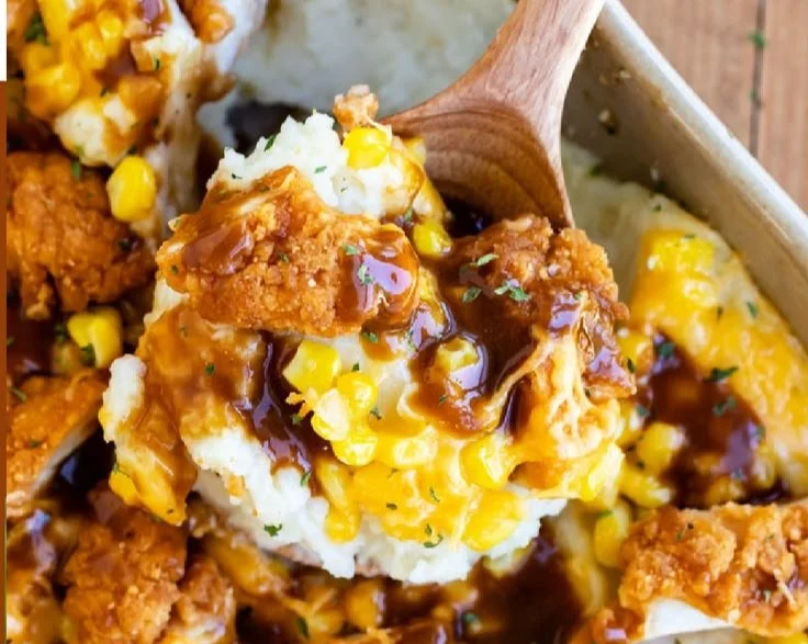 Delicious mashed potato casserole topped with crispy chicken, served warm.