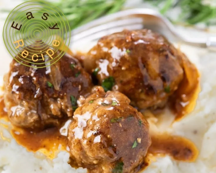 Savory meatballs in rich gravy served on a plate
