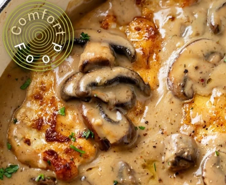 Mushroom Chicken served with creamy sauce and fresh herbs on a plate