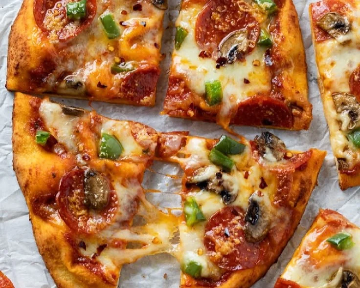 Homemade Naan Pizza topped with fresh vegetables and cheese.