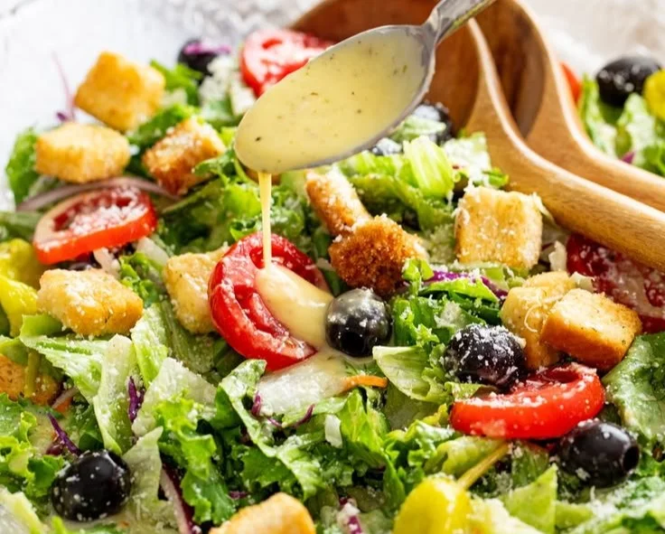 Delicious Olive Garden Salad in a bowl with fresh vegetables and dressing