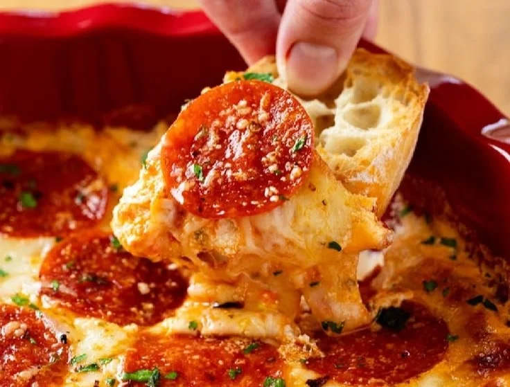 Delicious and creamy pizza dip served with crunchy tortilla chips