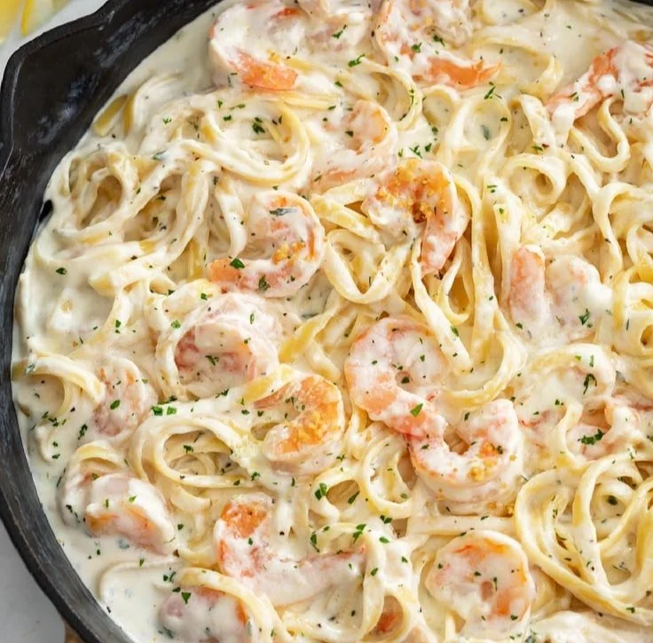 Creamy Shrimp Alfredo pasta dish served with garnishes