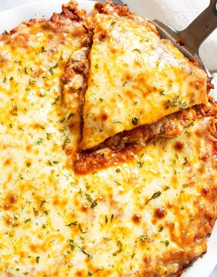 Delicious homemade spaghetti pie served on a plate with herbs