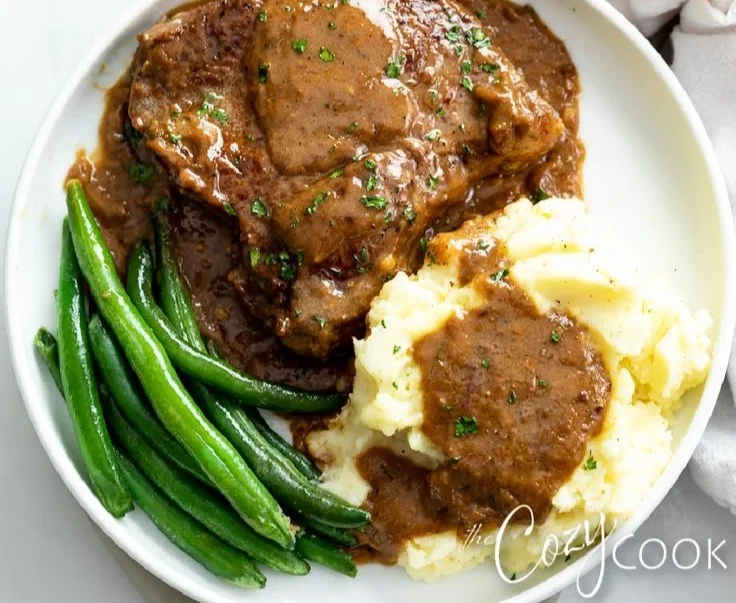Juicy steak served with savory gravy on a plate