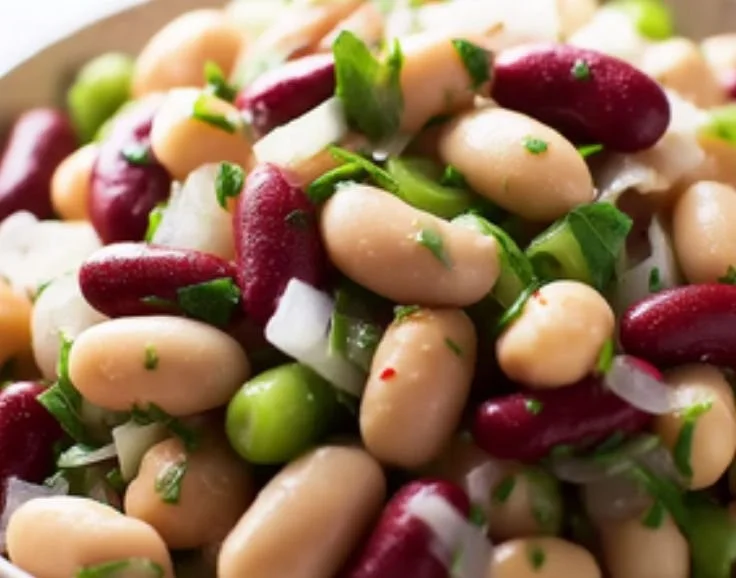 Colorful Three Bean Salad with fresh vegetables and dressing in a bowl