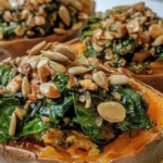 Creamy sunflower seed and spinach stuffed sweet potatoes on a plate