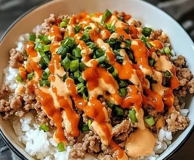 Delicious Bang Bang Ground Turkey Rice Bowls served in a bowl with fresh toppings