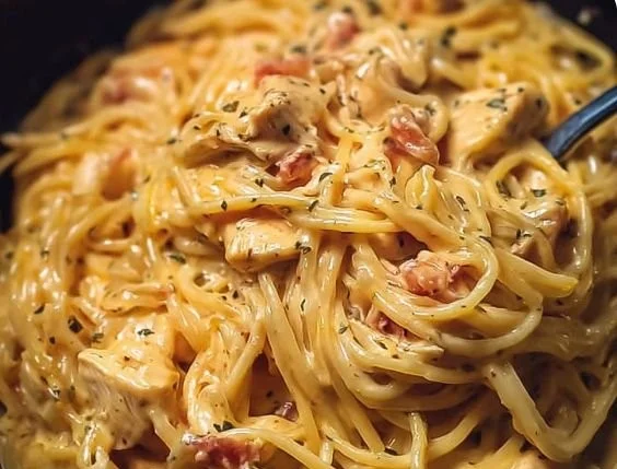 Delicious crockpot cheesy chicken spaghetti with creamy cheese sauce and pasta