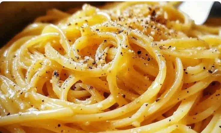 Bowl of easy one-pot miso butter pasta with vibrant green herbs on top