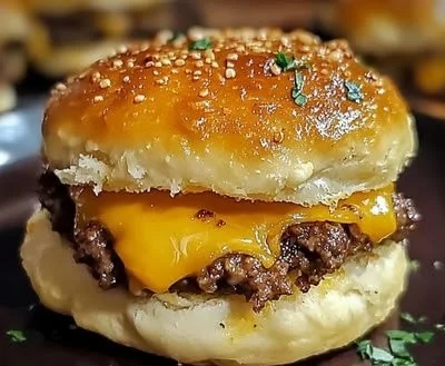 Garlic Parmesan Cheeseburger Bombs with melted cheese, juicy beef, and garlic topping.