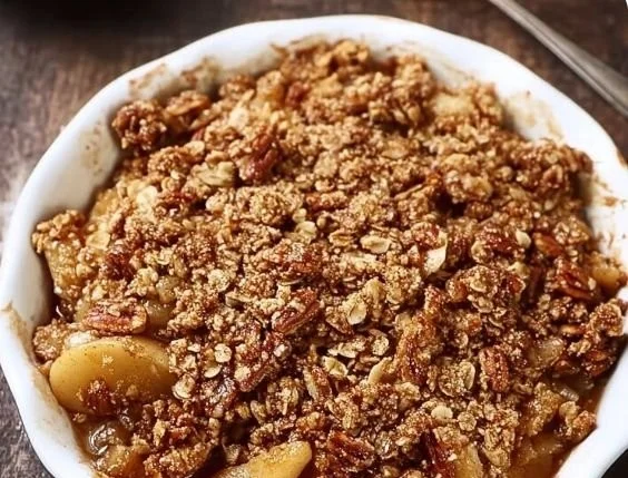 Healthy apple crisp with oatmeal pecan topping served in a bowl