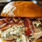 Slow Cooker Chicken Bacon Ranch Sandwiches served on a plate with garnish